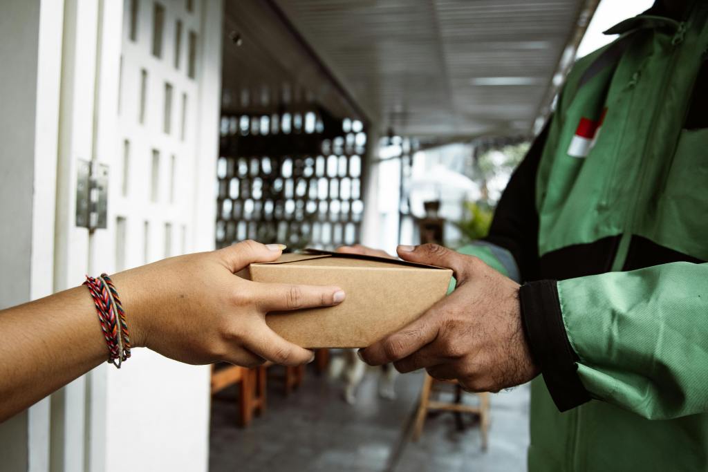 customer receiving parcel from delivery person